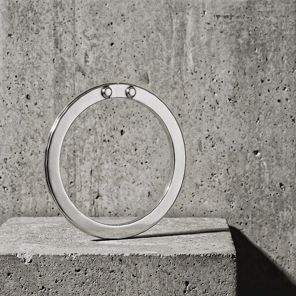 Flat rectangular profile and mirror-polished sterling silver surface, riveted node at top of circle