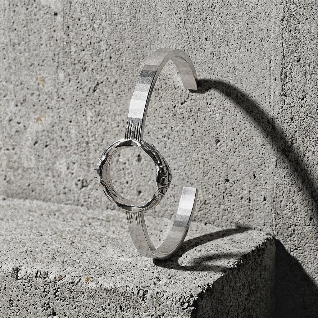 Twin-band sculptural cuff with Spiked module visible on front face on concrete surface, A Gross Domestic Product