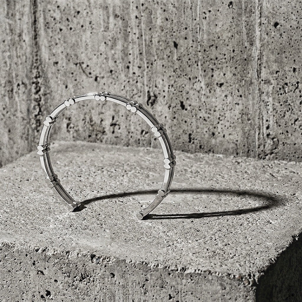 Sterling silver cuff showing the rhythm of block modules and parallel rails on concrete surface, 925 silver