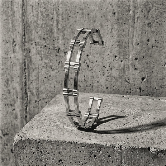 Architectural twin-rail cuff with perpendicular block modules upright on concrete pedestal, A Gross Domestic Product