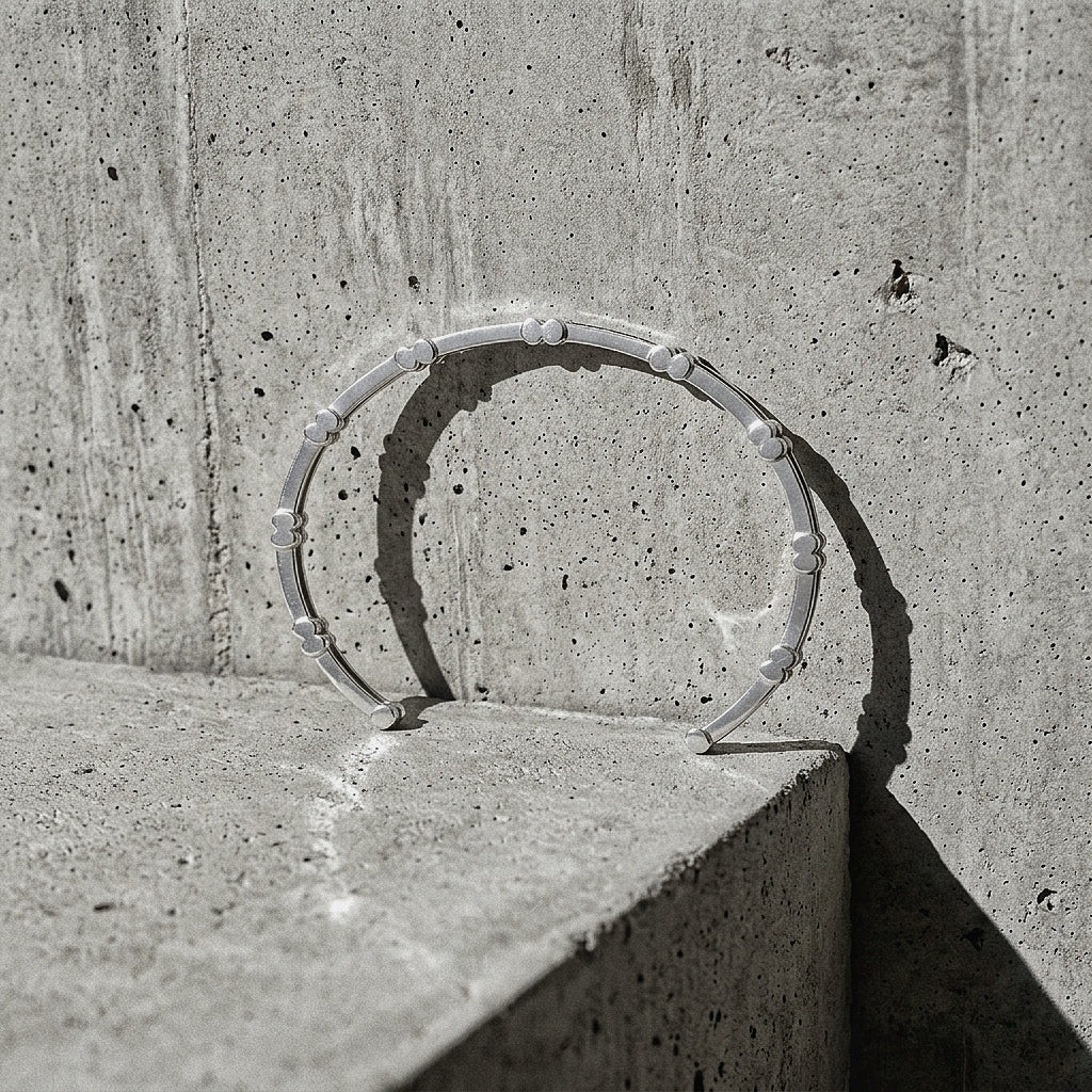 Ten Cuff Bracelet and Solitaire Ring in sterling silver on concrete edge — Link collection